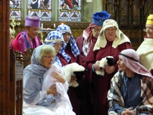 Mary is holding the baby Jesus watched by Joseph, the Kings and the Shepherds in the 'Inside the Stable' scene